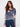 Denim blue sweater with a V-neck and floral print, showcasing its relaxed fit, by Charlie B.