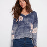 Denim blue sweater with a V-neck and floral print, showcasing its relaxed fit, by Charlie B.