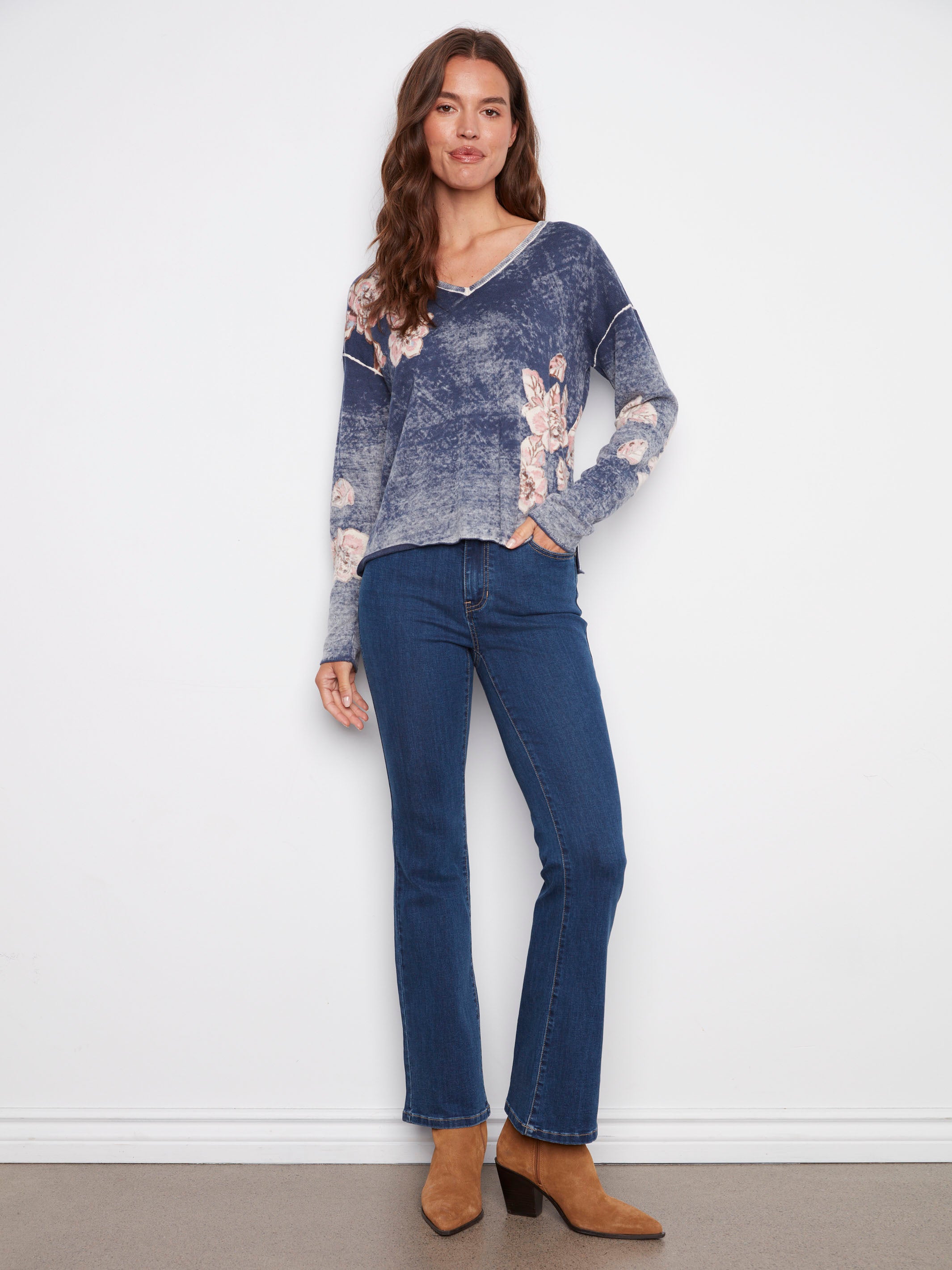 Reversible design in this denim blue sweater with long sleeves and floral motifs by Charlie B.