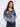 V-neck denim blue sweater highlighted with a relaxed fit and charming floral prints by Charlie B.