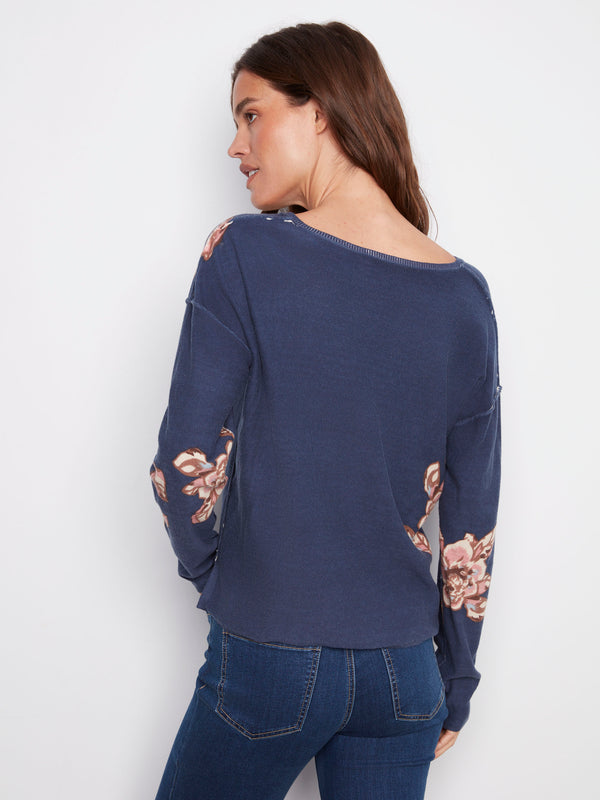Chic relaxed fit V-neck sweater in denim blue featuring an elegant floral design by Charlie B.