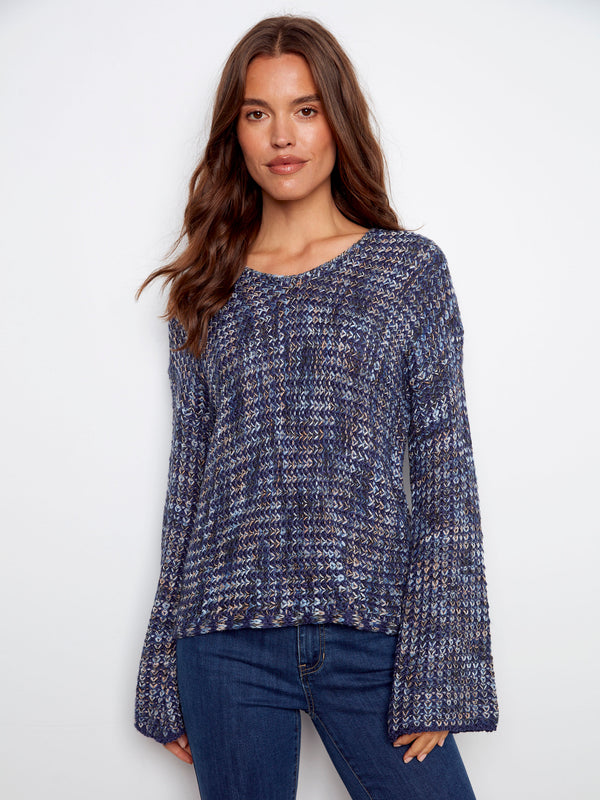 This sweater boasts long sleeves in a blue multi-tone crochet pattern, made with novelty yarn by Charlie B.