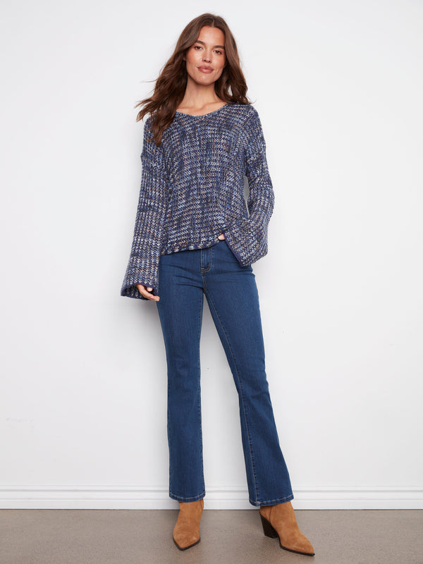 Featuring a unique drop shoulder design, this blue multi-tone crochet sweater is crafted with care by Charlie B.