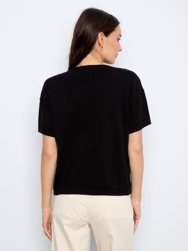 Elegant elbow sleeve design on a floral-patterned black cotton sweater by Charlie B.