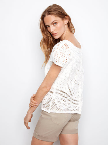 Button-down front detail elevates the classic look of this intricate white crochet blouse by Charlie B.