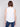Chic sleeveless design on a white linen top by Charlie B.