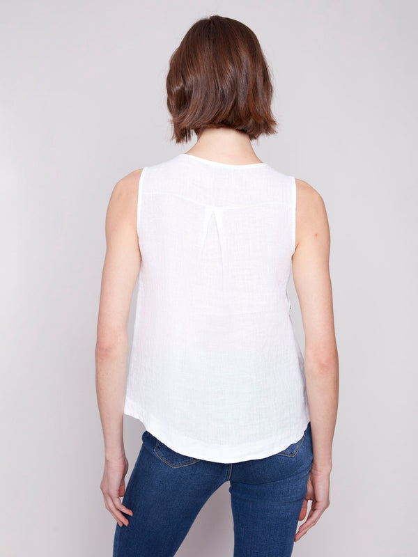 Chic sleeveless design on a white linen top by Charlie B.