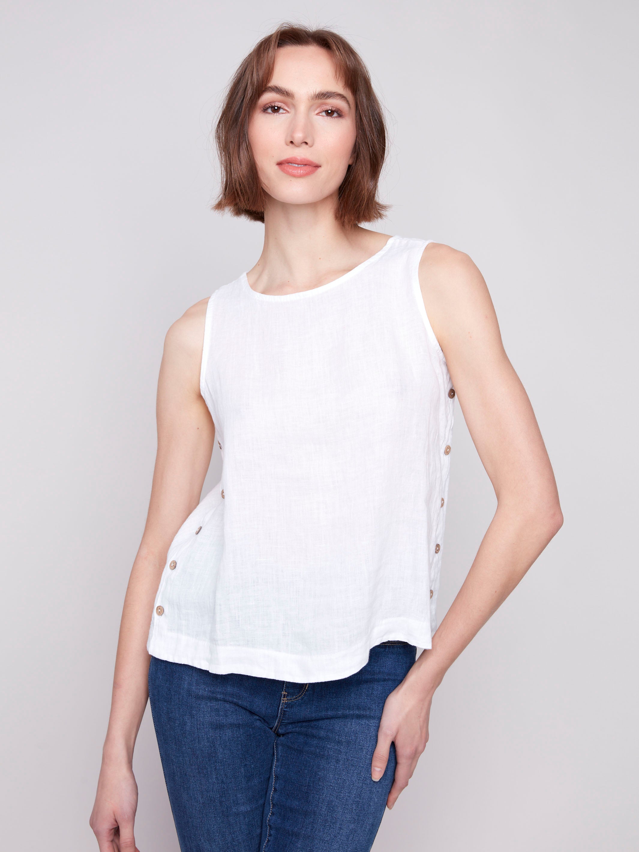 Distinctive side button detailing on a white tank top by Charlie B.