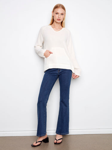 Featuring an effortlessly chic look, this piece includes practical kangaroo pockets and is made from pure cotton material by Charlie B.
