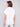 White shirt featuring one shoulder feather design by Charlie B.