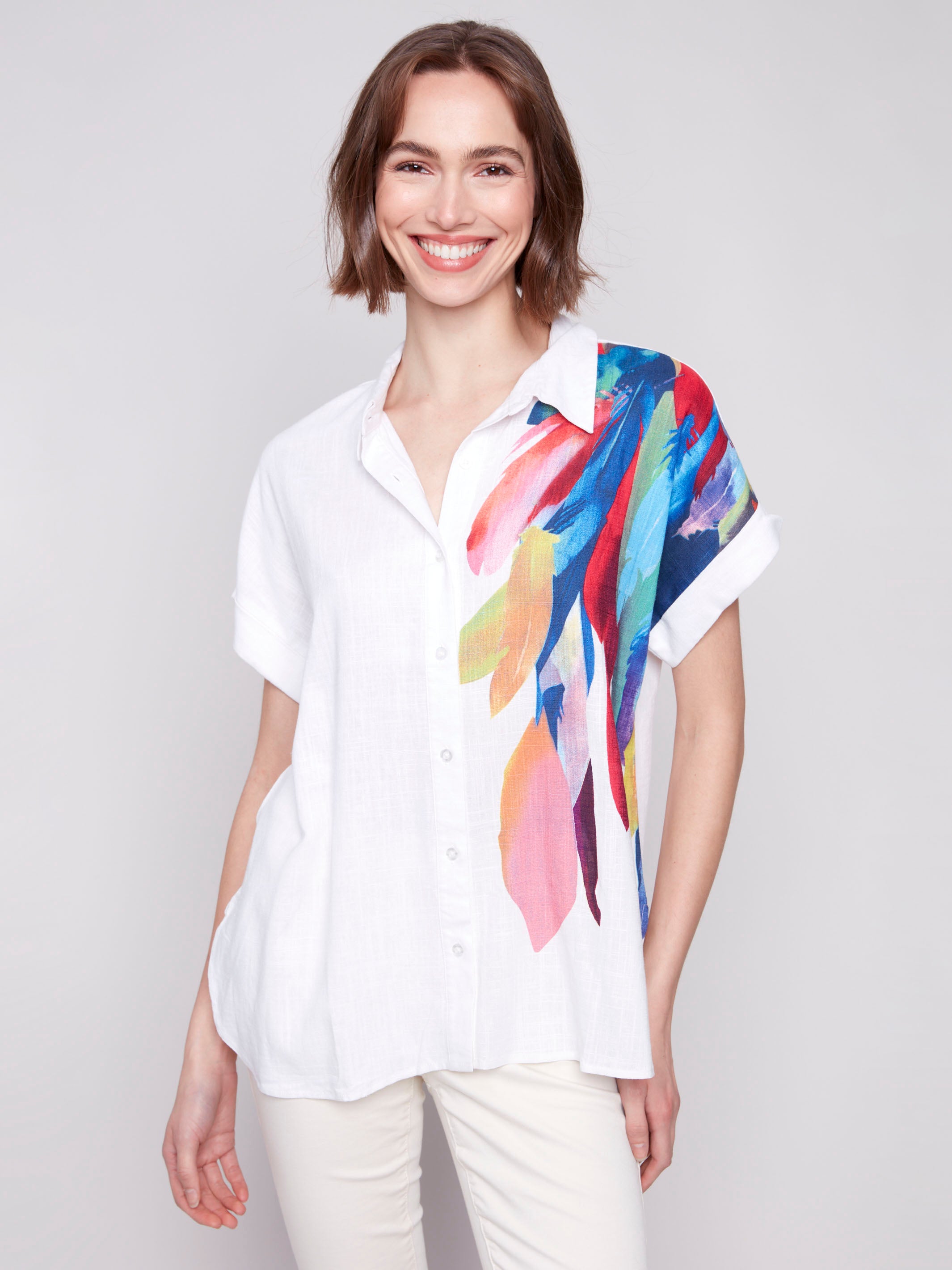 Dolman short-sleeve shirt with vibrant feathers by Charlie B.