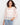 Crochet sweater featuring a boat neckline and intricate floral patterns, offering a chic style in a cotton blend by Charlie B.