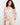 White crochet top with pink floral pattern and boat neckline by Charlie B.