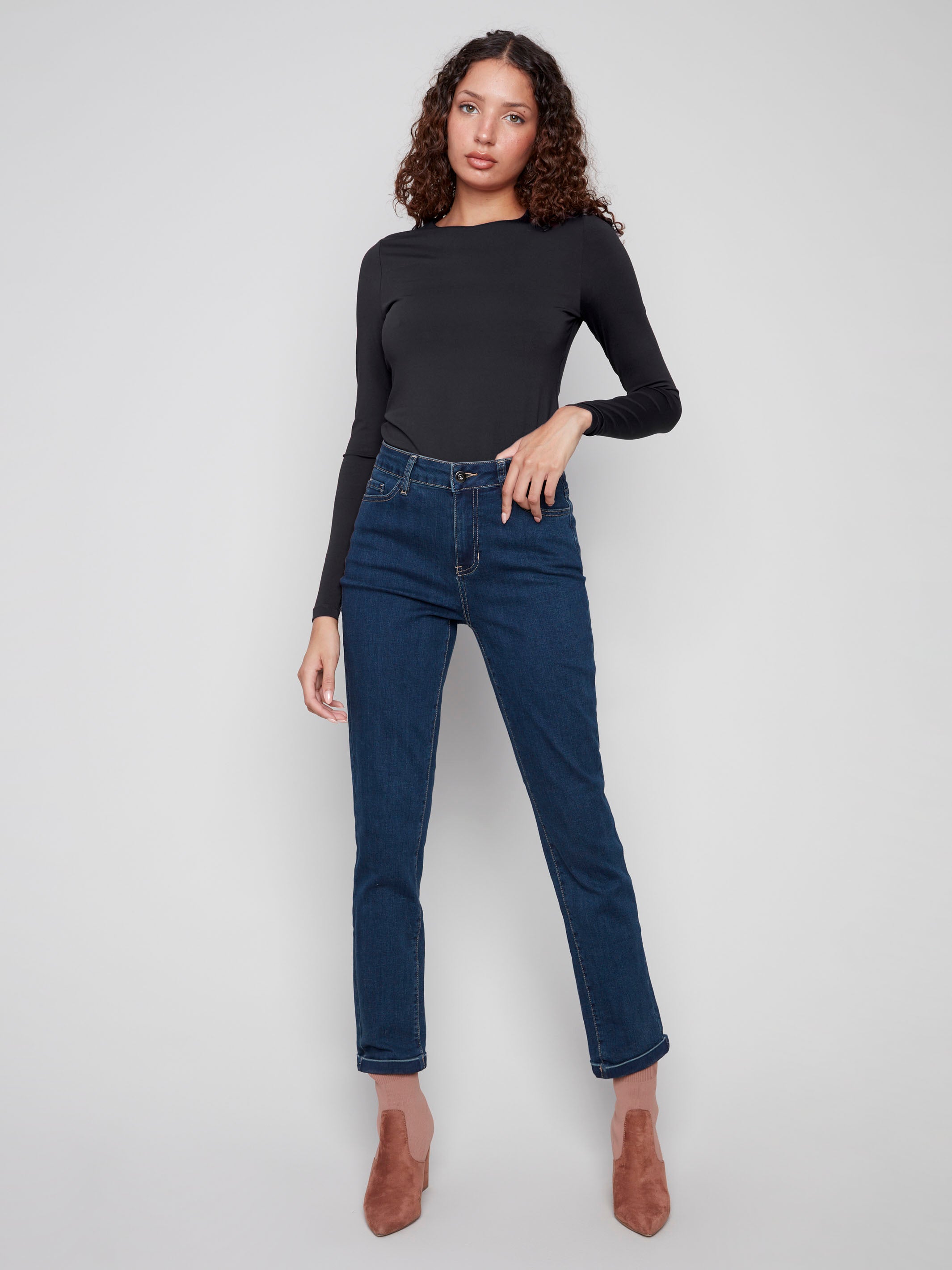 Dark blue slim leg jeans with a cuffed hem, featuring a classic five-pocket design and button closure by Charlie B.