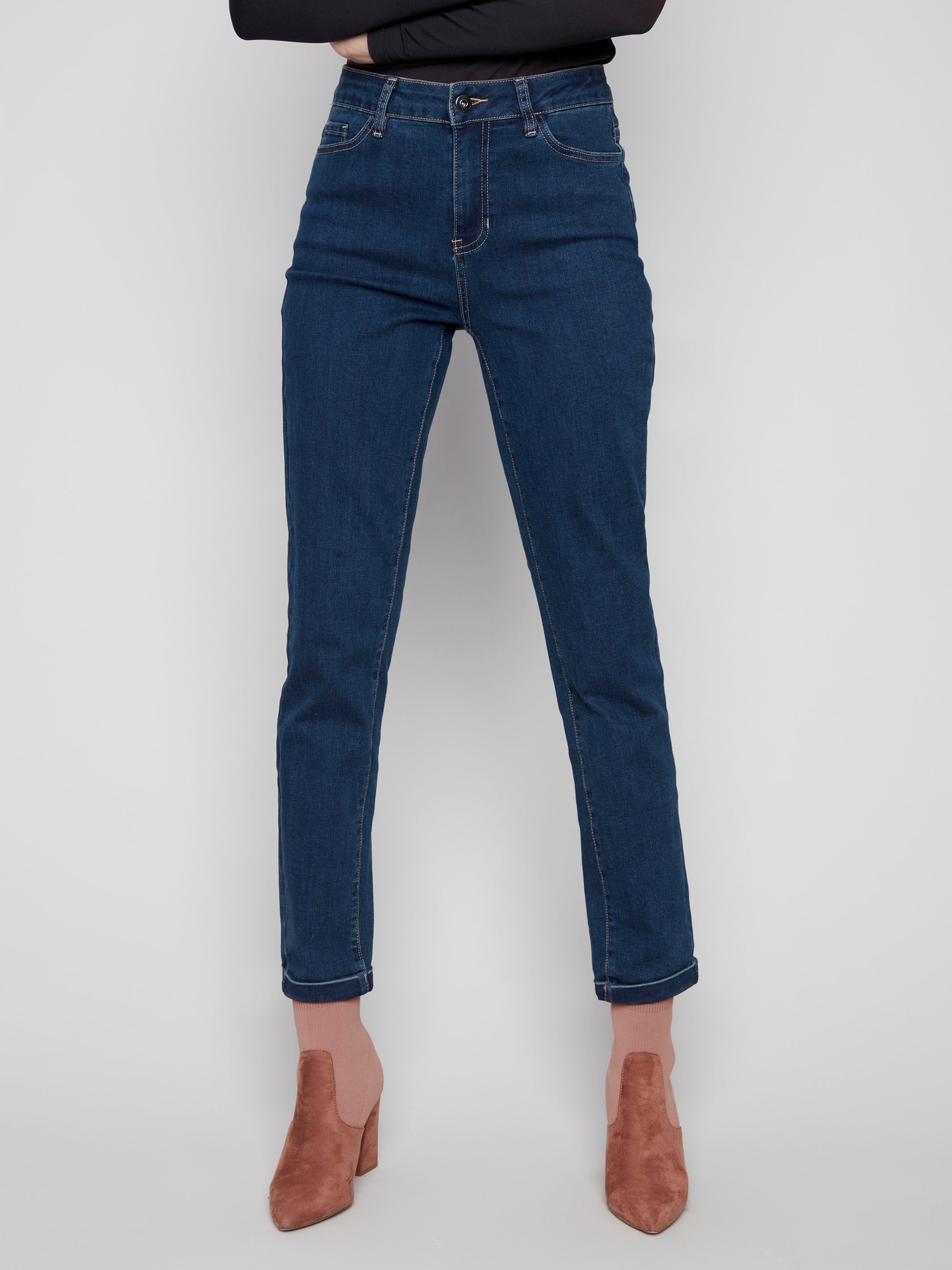 Dark blue slim leg jeans with a cuffed hem, featuring a classic five-pocket design and button closure by Charlie B.