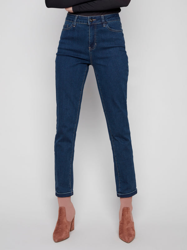 Dark blue slim leg jeans with a cuffed hem, featuring a classic five-pocket design and button closure by Charlie B.