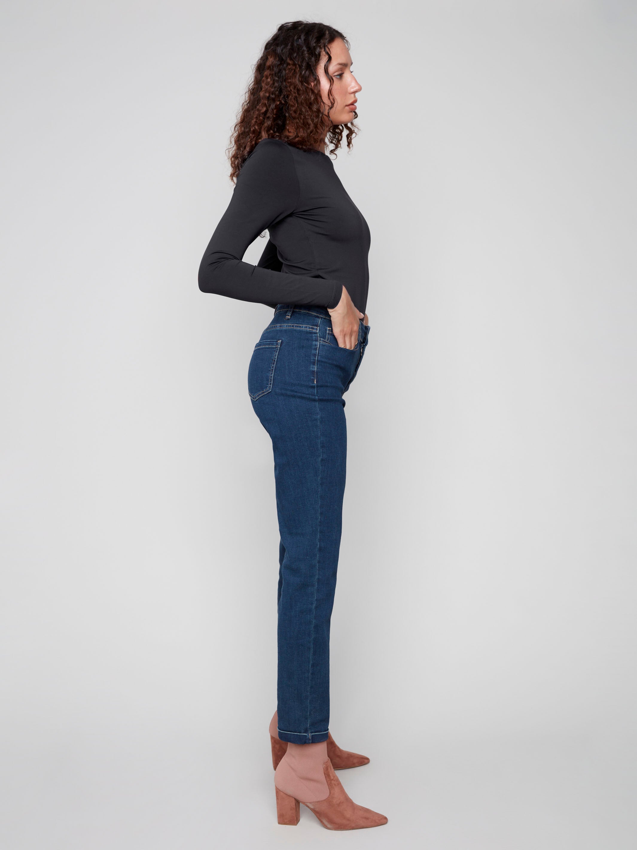 Dark blue slim leg jeans with a cuffed hem, featuring a classic five-pocket design and button closure by Charlie B.