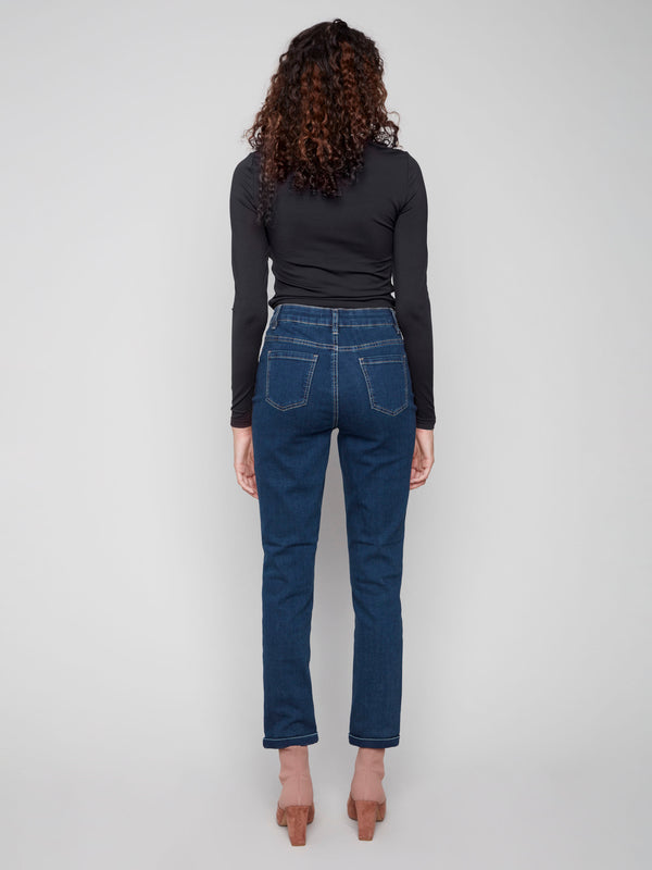 Dark blue slim leg jeans with a cuffed hem, featuring a classic five-pocket design and button closure by Charlie B.