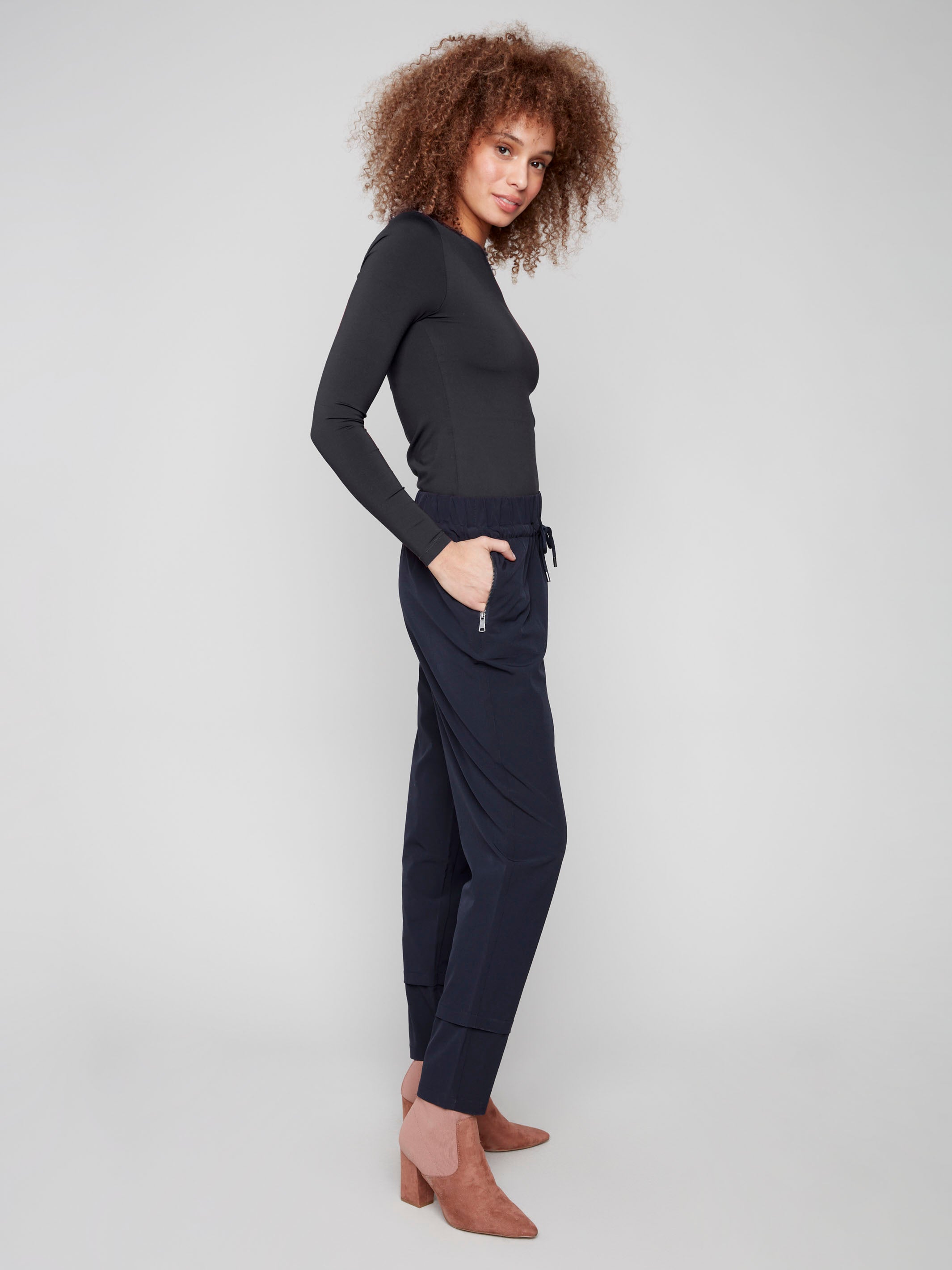 Navy slim-leg techno pants with side zip pockets, offering practical storage and stylish design by Charlie B.