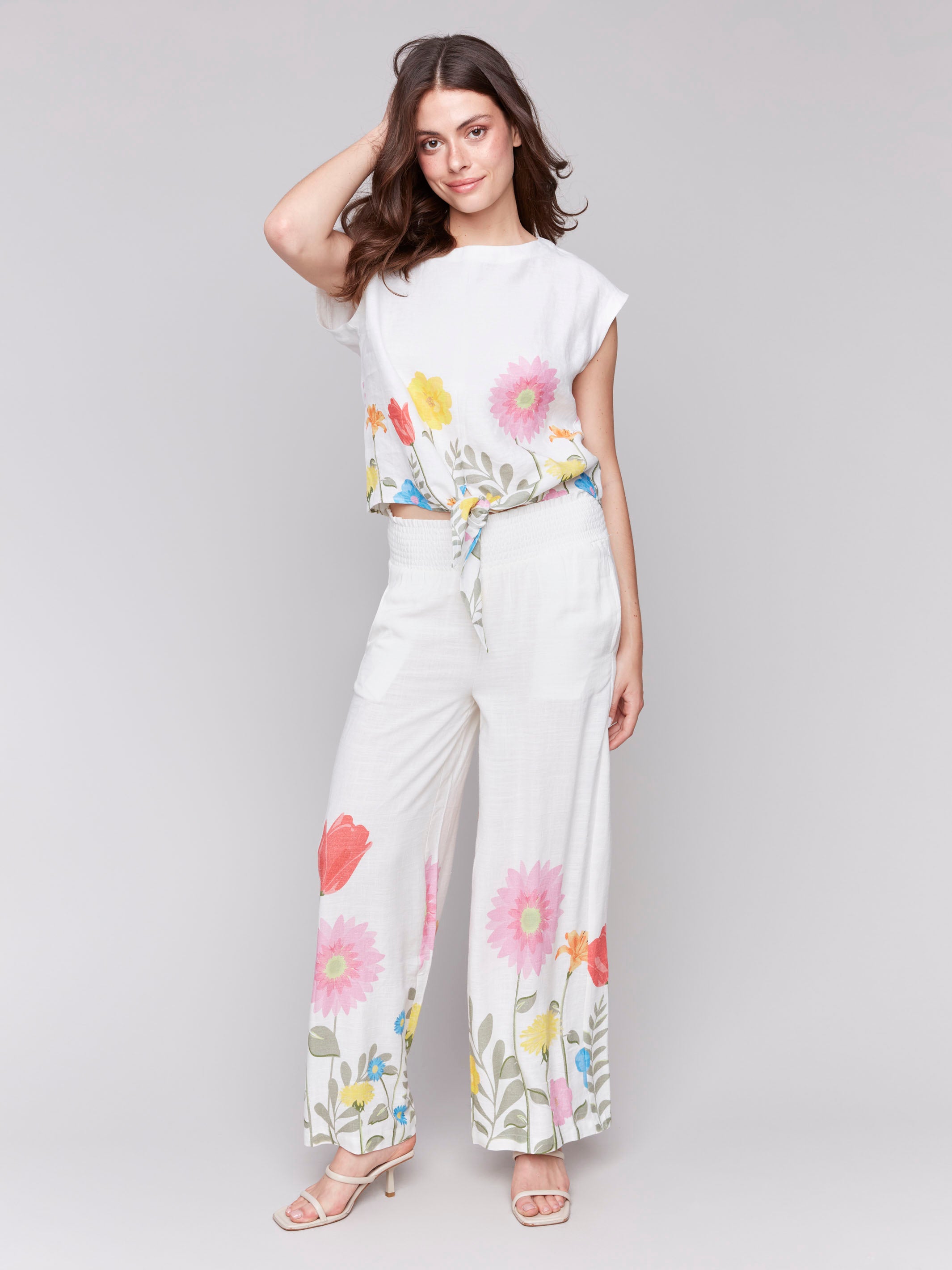 Elegant cap sleeves enhance this beautifully designed blouse by Charlie B.