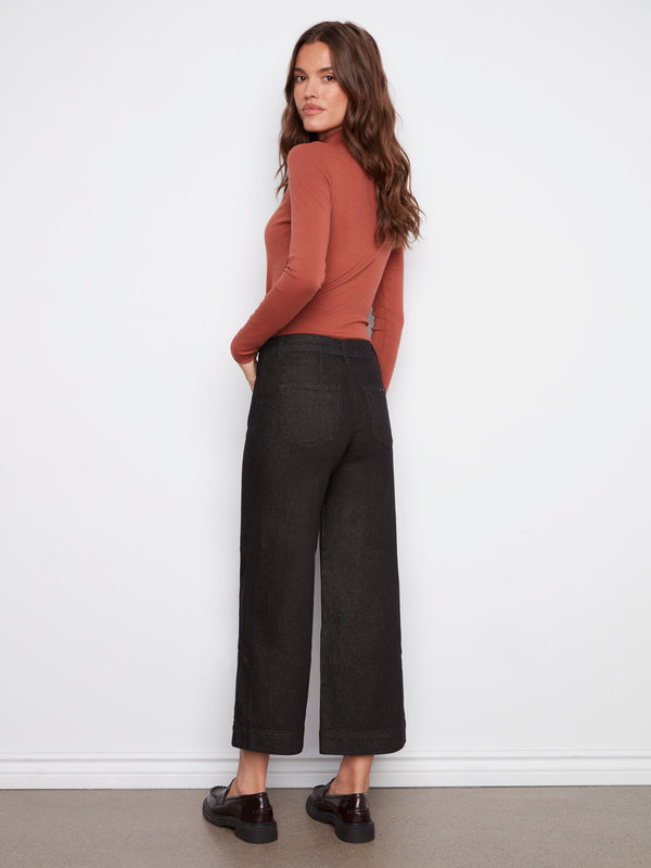 Elegant cropped length black jeans designed with a regular rise and metallic details by Charlie B.