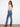 Bootcut jeans in medium blue with intricate side floral details, crafted from stretch denim for ease of movement by Charlie B.