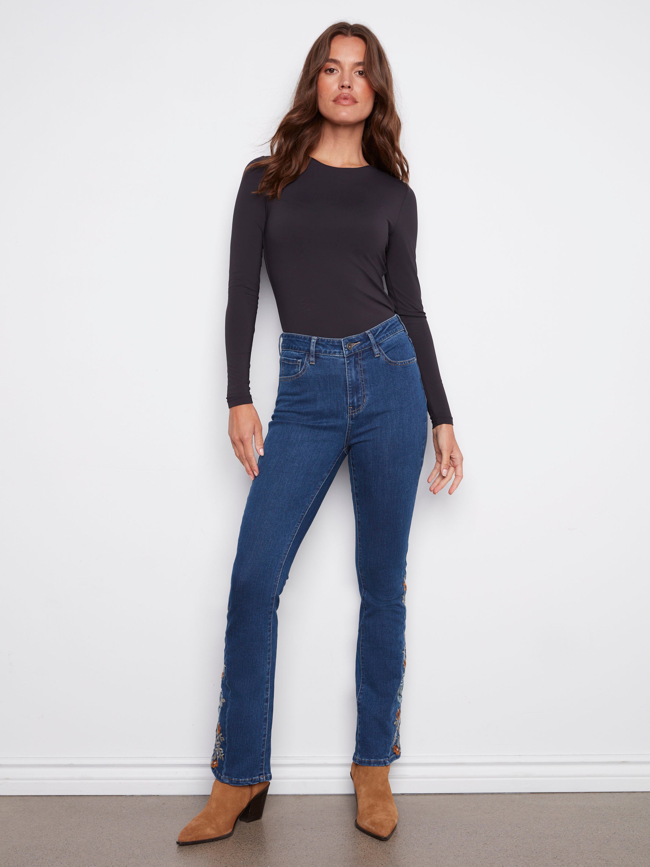 Indigo jeans with a bootcut fit and regular rise, featuring intricate floral embroidery for a stylish touch by Charlie B.
