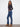 Long length indigo jeans crafted from stretch denim, adorned with elegant side floral embroidery by Charlie B.