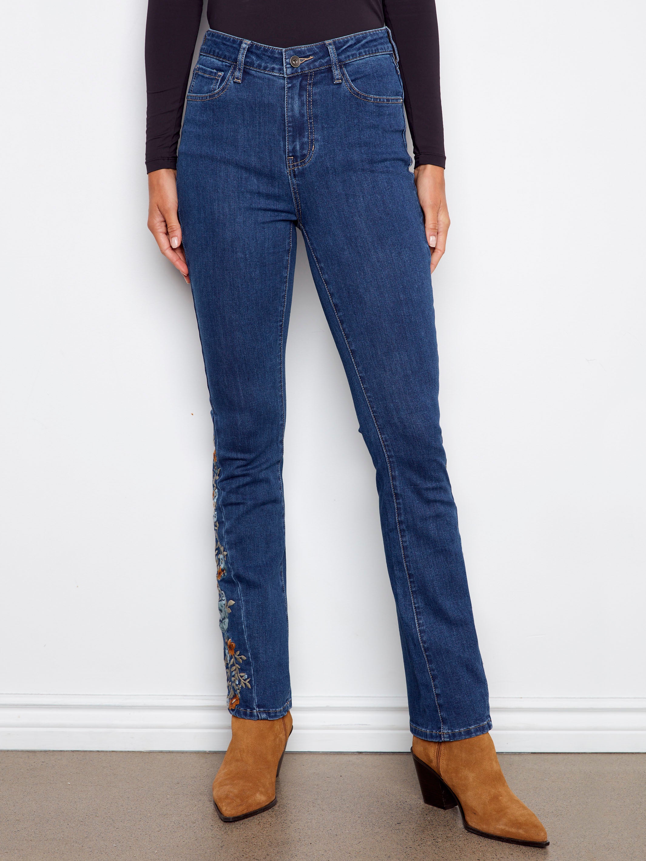 These indigo jeans have a five-pocket design and stretch denim for comfort, enhanced with floral side details by Charlie B.
