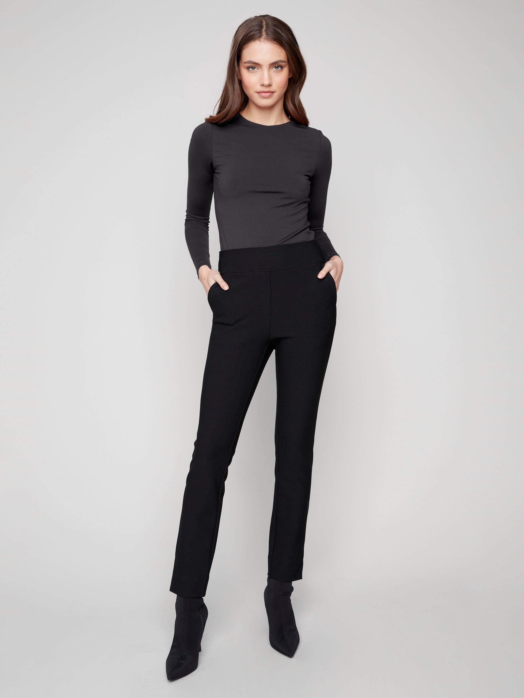 Black slim-fit dress pants with a comfortable elastic waistband and two back welt pockets, ideal for any occasion by Charlie B.