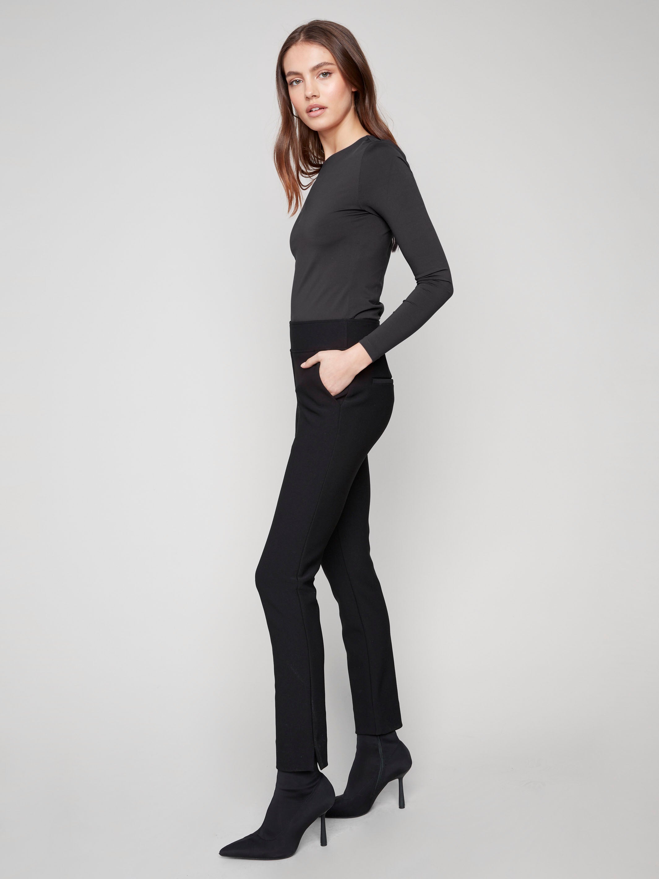 Elegant black dress pants showcasing a slit at the hem and an elastic waistband for enhanced comfort in every step by Charlie B.