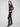 Elegant black dress pants showcasing a slit at the hem and an elastic waistband for enhanced comfort in every step by Charlie B.