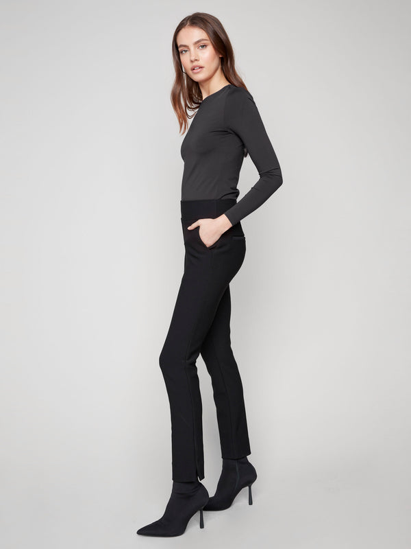 Elegant black dress pants showcasing a slit at the hem and an elastic waistband for enhanced comfort in every step by Charlie B.