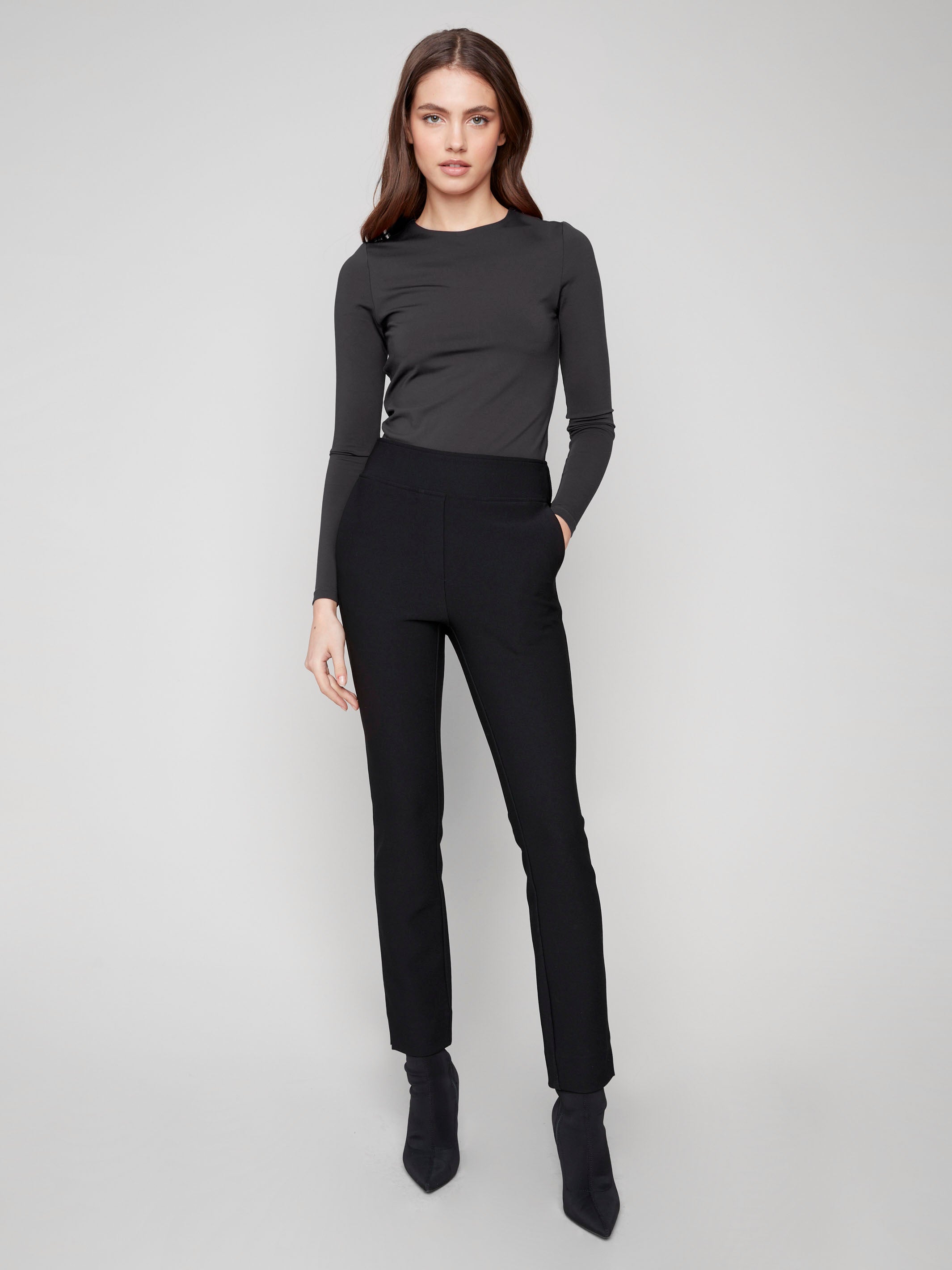 Dress pants in black with a flattering slim fit and practical side pockets, crafted from stretch fabric for ease of movement by Charlie B.