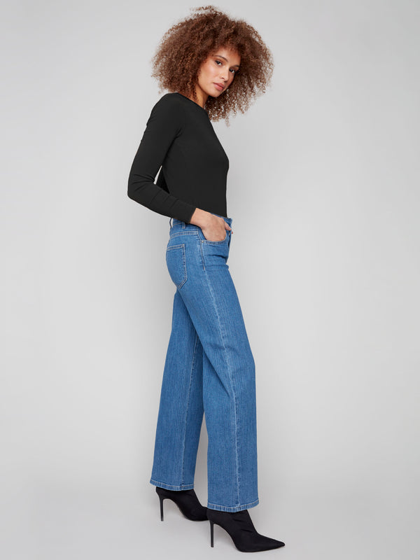 Long length blue jeans featuring a classic five-pocket design and striped pattern by Charlie B.