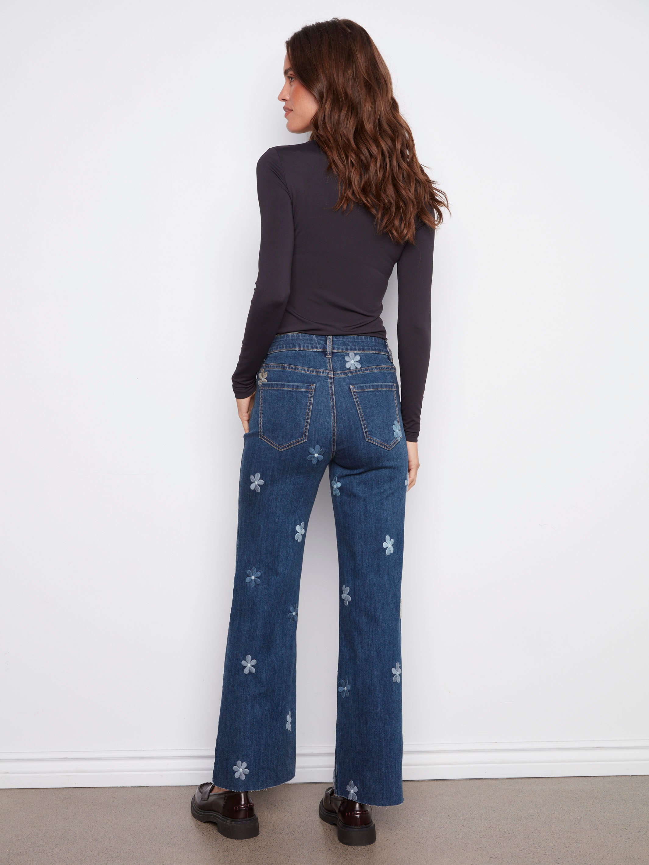 Embrace the five-pocket design of these indigo jeans adorned with lovely flower patches by Charlie B.