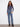 Medium blue jeans with a stylish raw hem and vibrant flower patches, offering a trendy look by Charlie B.