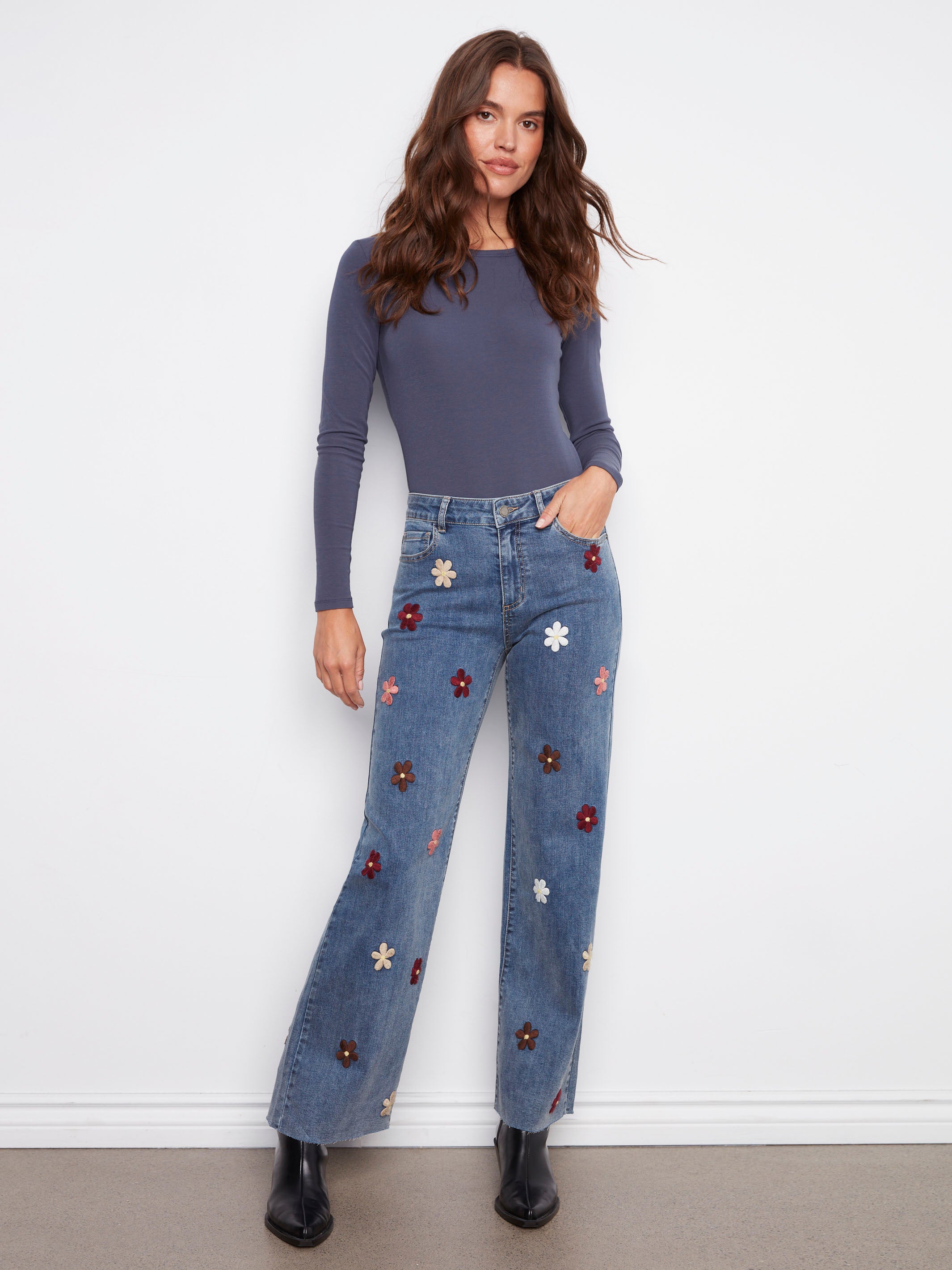 Stylish raw hem and stretch denim create an effortlessly chic look with these floral patch jeans by Charlie B.