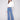 Blue jeans featuring a long length with intricate floral embroidery and sequins by Charlie B.