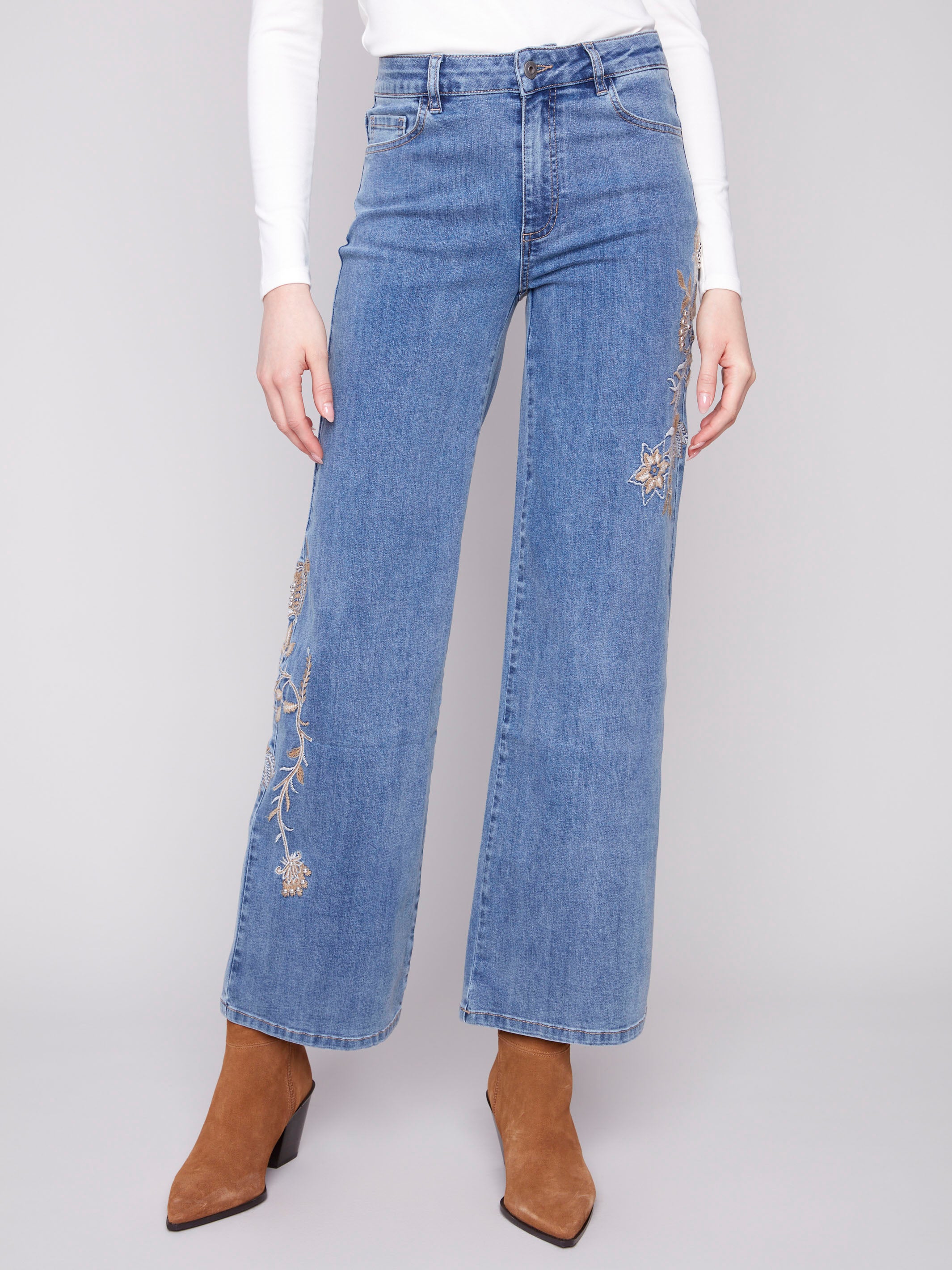 Stylish wide leg jeans crafted from stretch denim with embroidered flowers and studs by Charlie B.