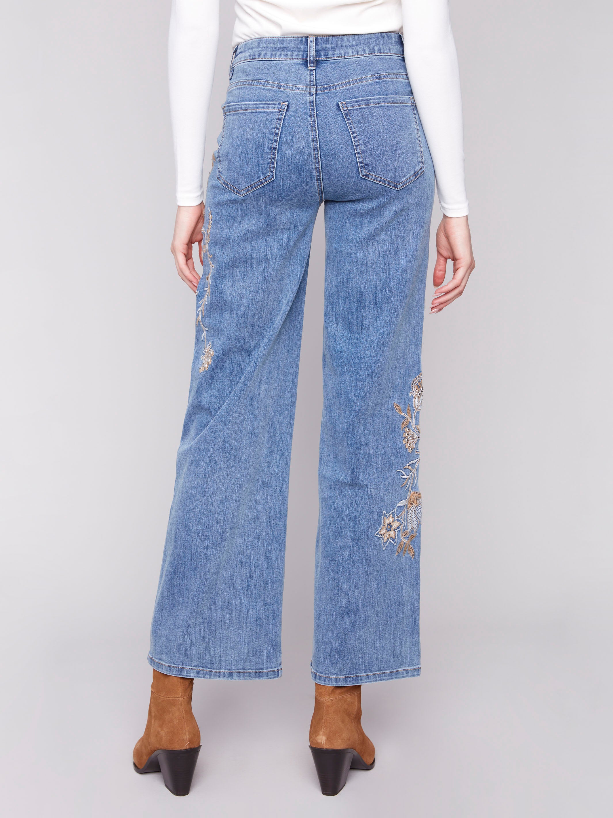 Regular rise blue jeans adorned with beautiful sequin and floral designs by Charlie B.