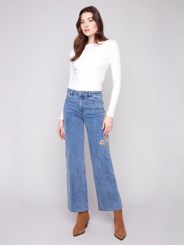 Elegant stretch denim jeans with detailed embroidery and classic five-pocket style by Charlie B.