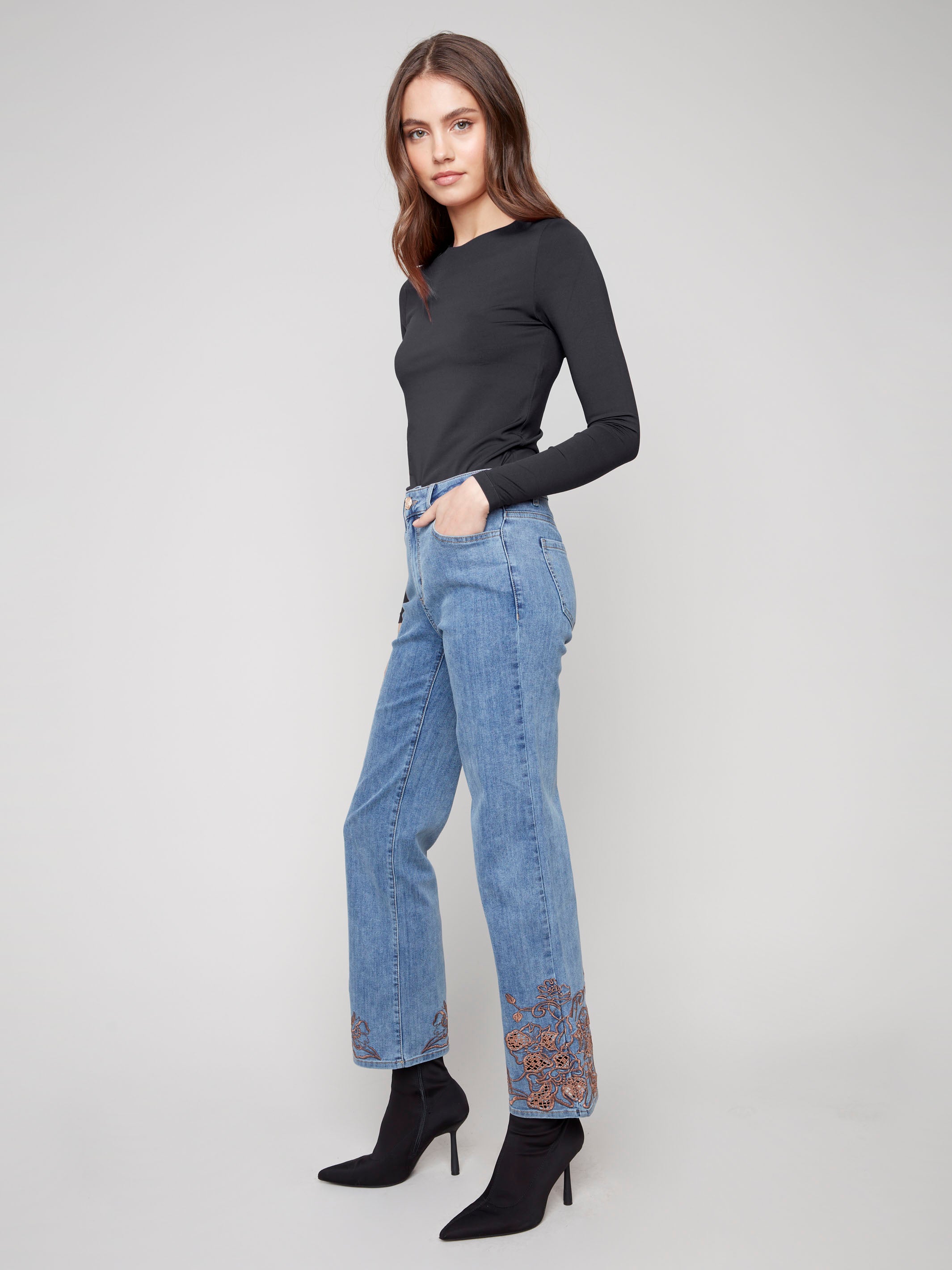 Featuring a classic five-pocket design, these medium blue jeans offer both functionality and fashion-forward style by Charlie B.