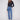 Medium blue denim jeans with a long length, featuring a button front closure and five-pocket design by Charlie B.