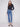 Medium blue denim jeans with a long length, featuring a button front closure and five-pocket design by Charlie B.