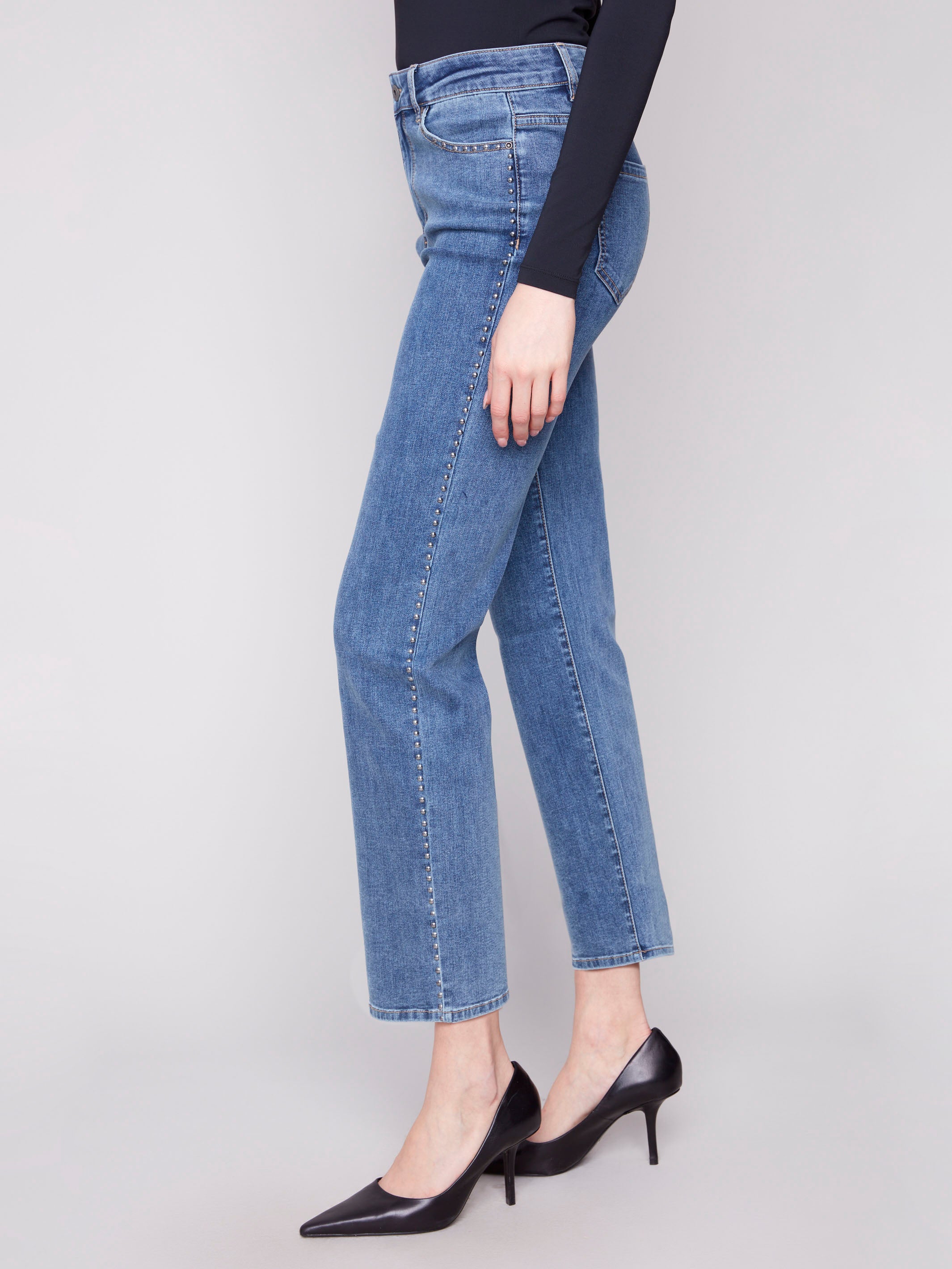 Denim jeans in medium blue with regular rise, highlighted by side stud details and classic style by Charlie B.