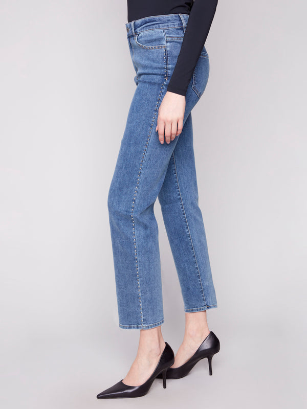 Denim jeans in medium blue with regular rise, highlighted by side stud details and classic style by Charlie B.