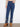 Stretch denim jeans in indigo featuring intricate metallic floral embroidery at the hem for added elegance by Charlie B.