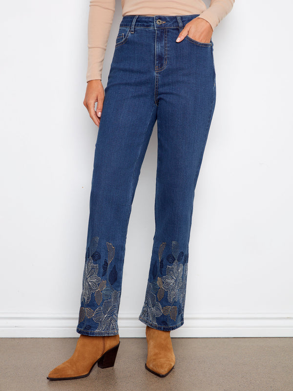 Stretch denim jeans in indigo featuring intricate metallic floral embroidery at the hem for added elegance by Charlie B.