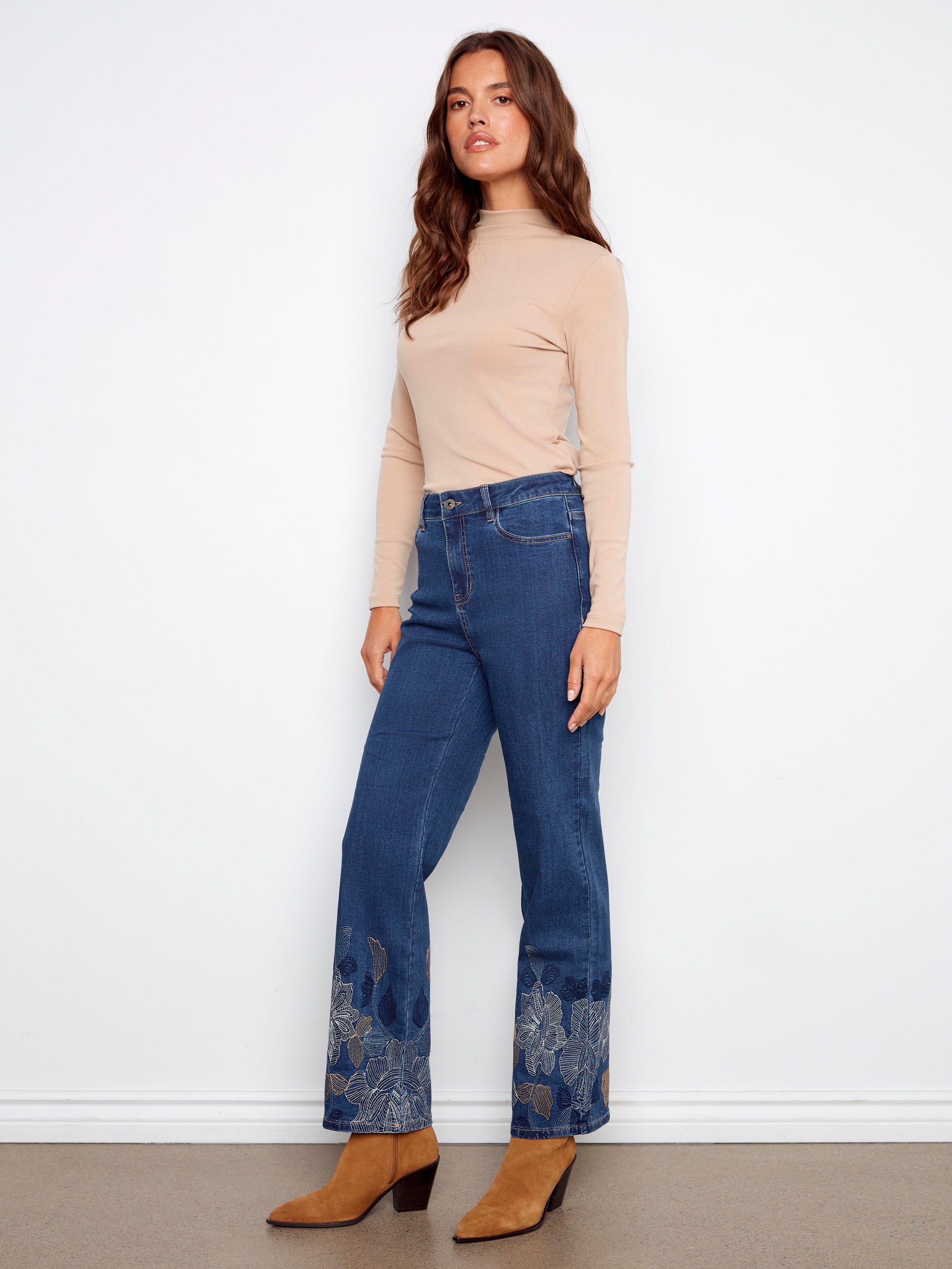 Regular rise indigo jeans with stunning metallic floral patterns at the hem, crafted for comfort and style by Charlie B.